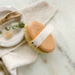 Oval beechwood dry brush with sisal bristles and white strap on handle
