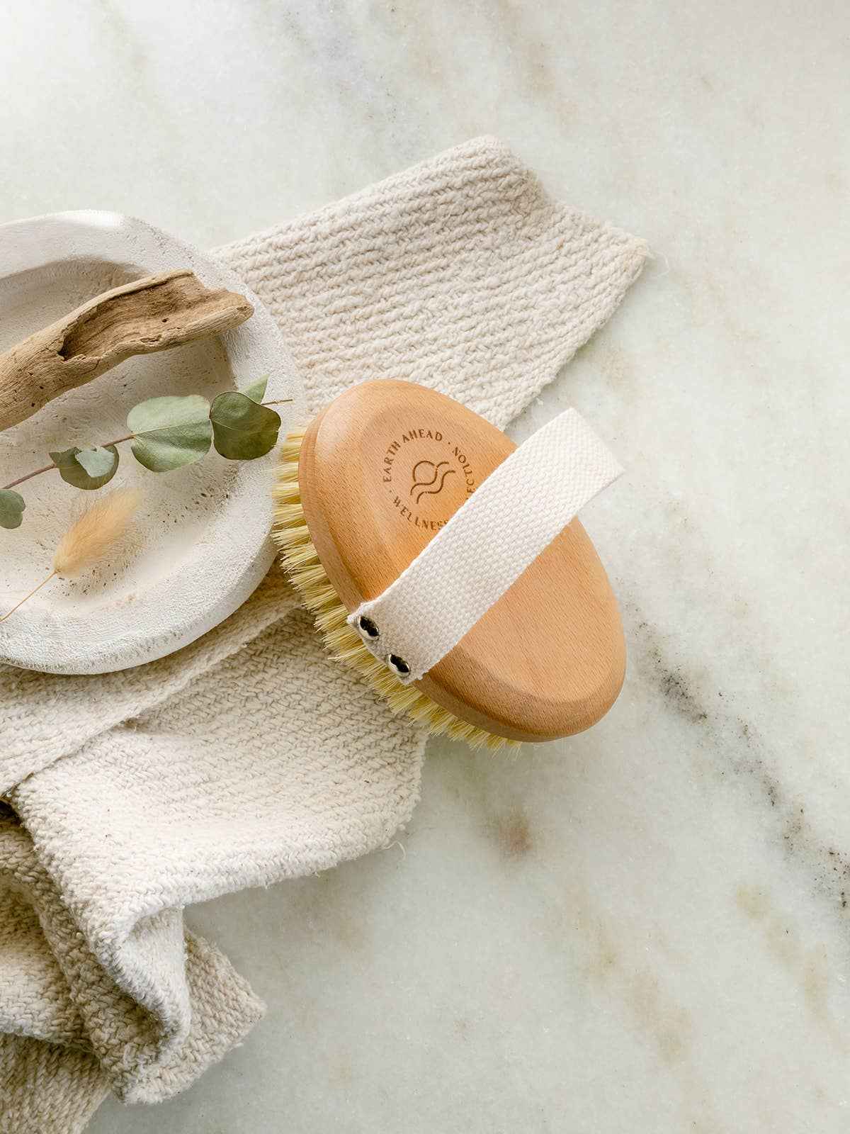Oval beechwood dry brush with sisal bristles and white strap on handle