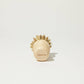 Circular wooden scrub brush with natural bristles and short handle.