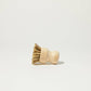 Angled wooden scrub brush with natural bristles and rounded handle.