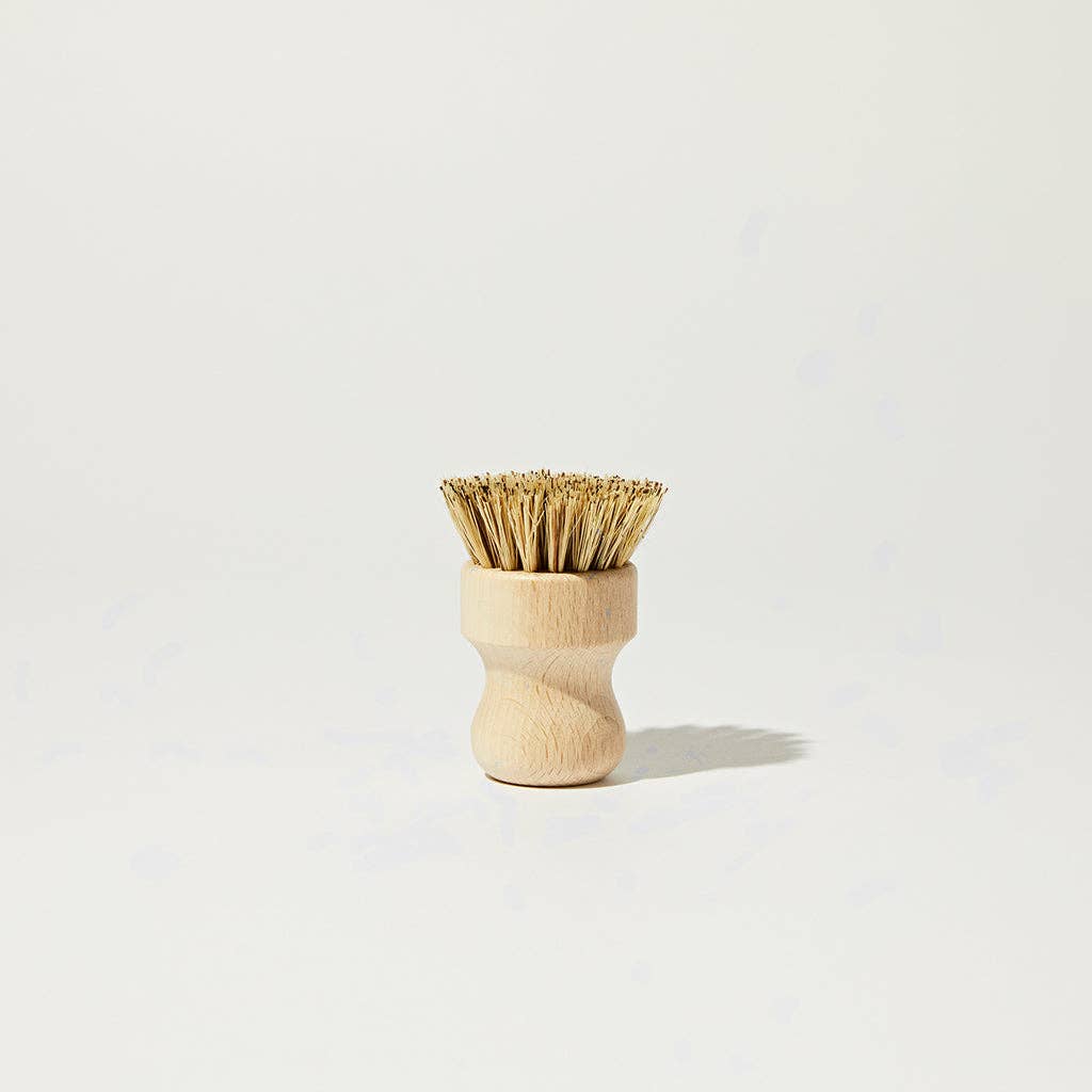 Wood scrub brush with natural bristles, short handle.