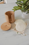 Bamboo storage box with stacked hemp cotton rounds and drawstring bag