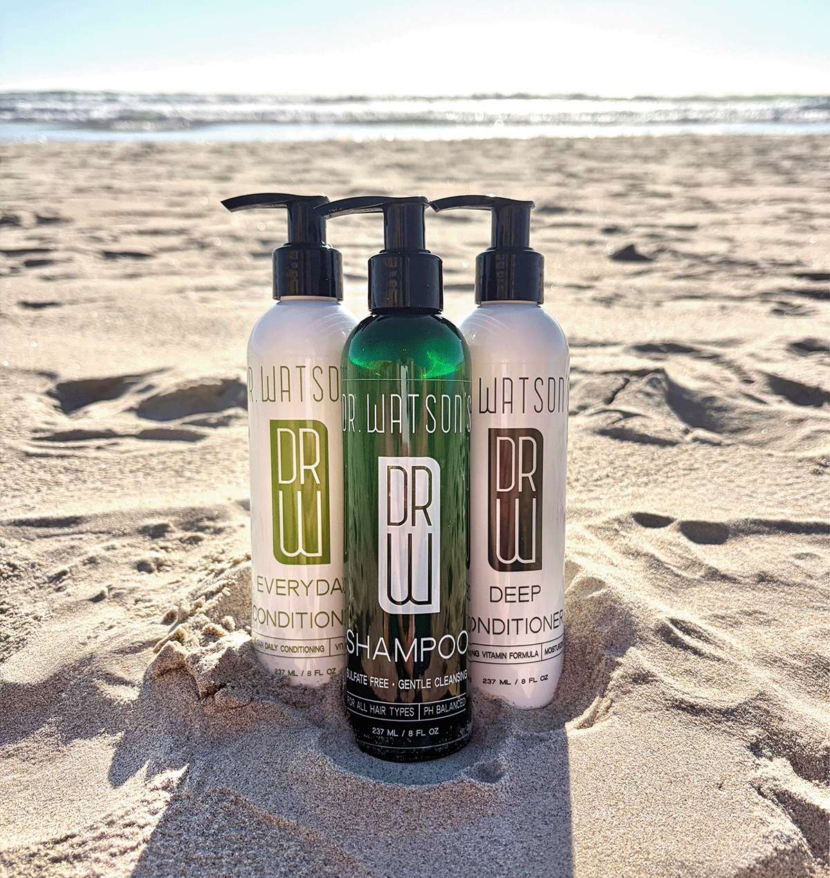 Trio of pump bottles: dark green deep conditioner and white everyday shampoo/conditioner.