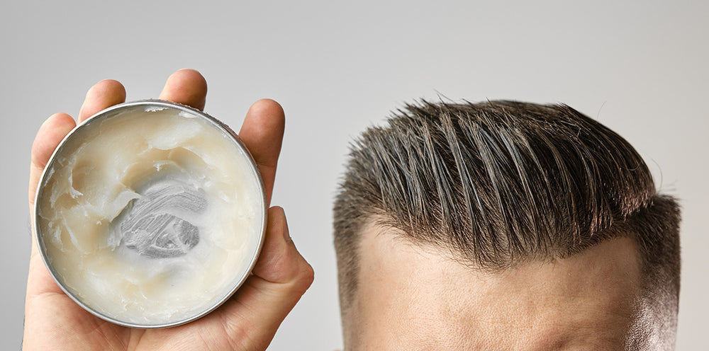 Man with pomade in hair from tin