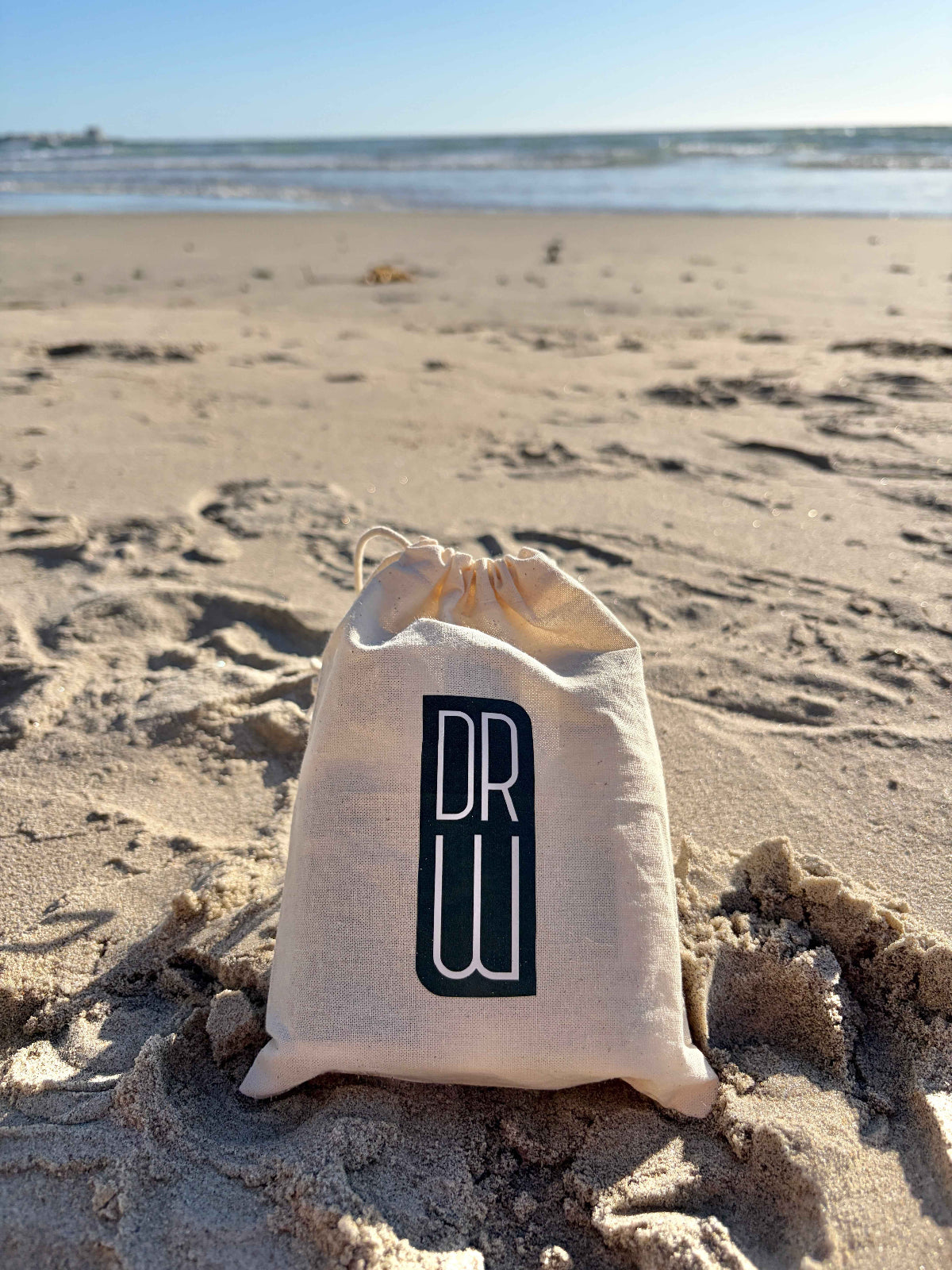 Cream drawstring sample pouch with Dr. Watson logo print