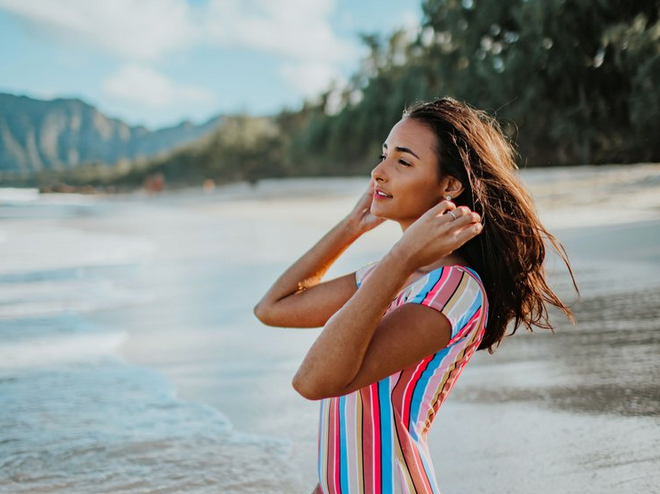 Woman with stripped shirt on the beach