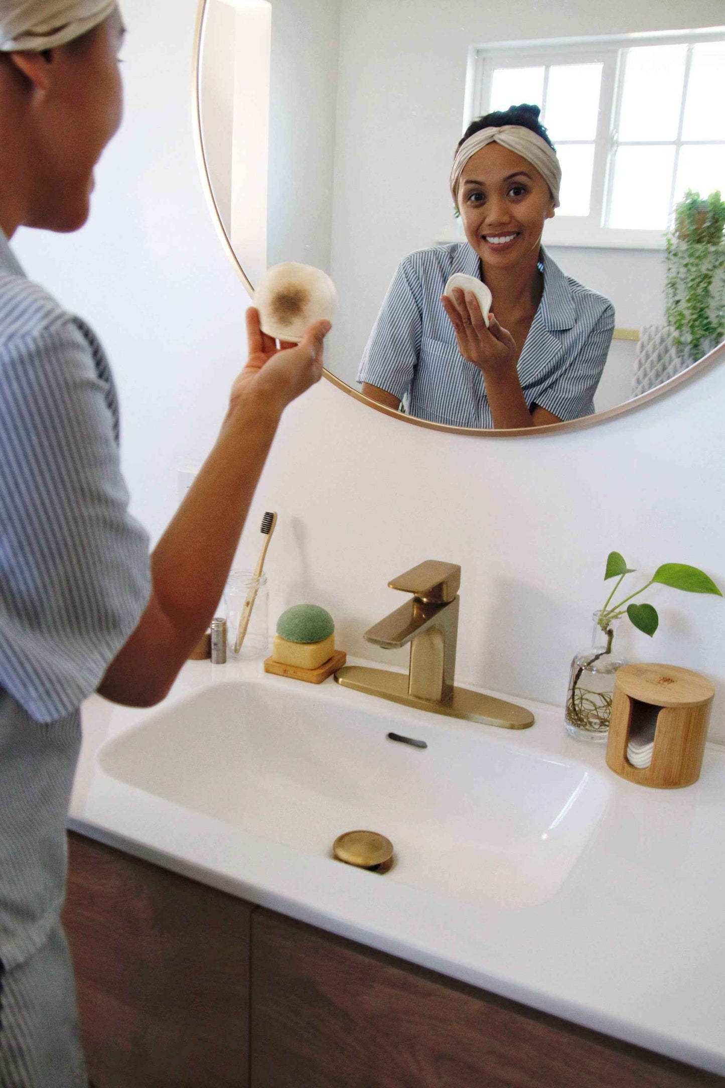 Hemp cotton round held above countertop beside bamboo storage box
