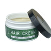 Dr. Watson's hair cream jar with black lid, open showing pale cream.