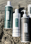 Trio of Dr. Watson's shampoo, conditioner, and body wash bottles