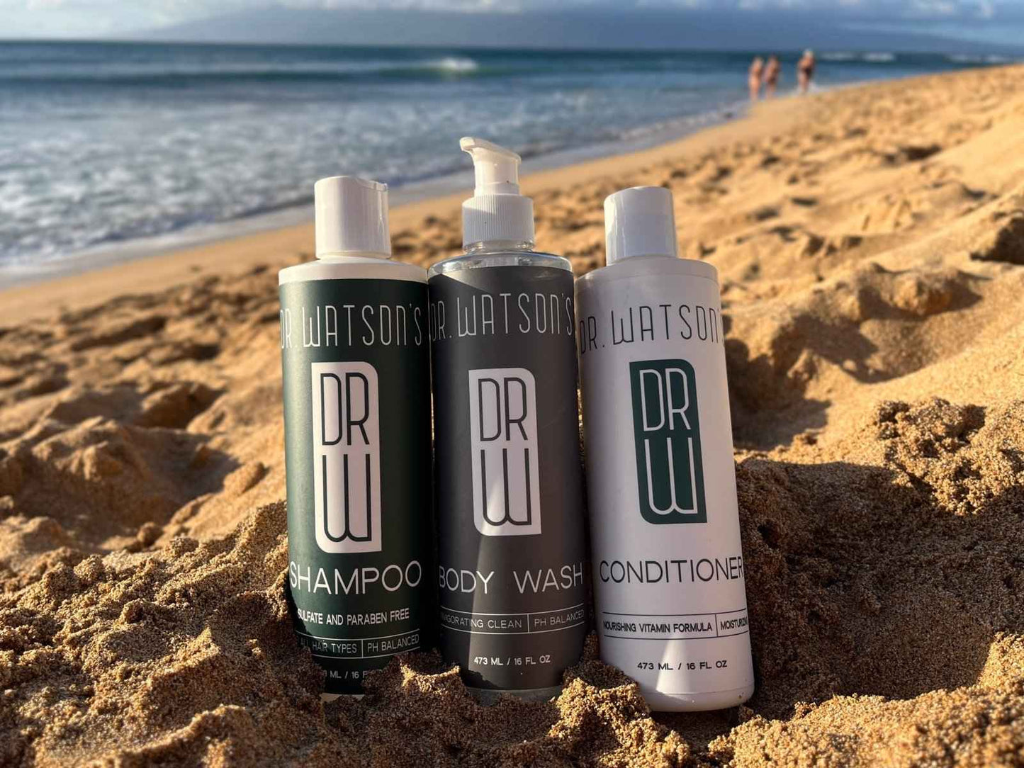 Three Dr. Watson's bottles—shampoo, body wash, and conditioner