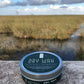 Hair dry wax tin with teal top label and silver rim