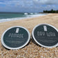 Hair dry wax jar with dark teal label and silver rim