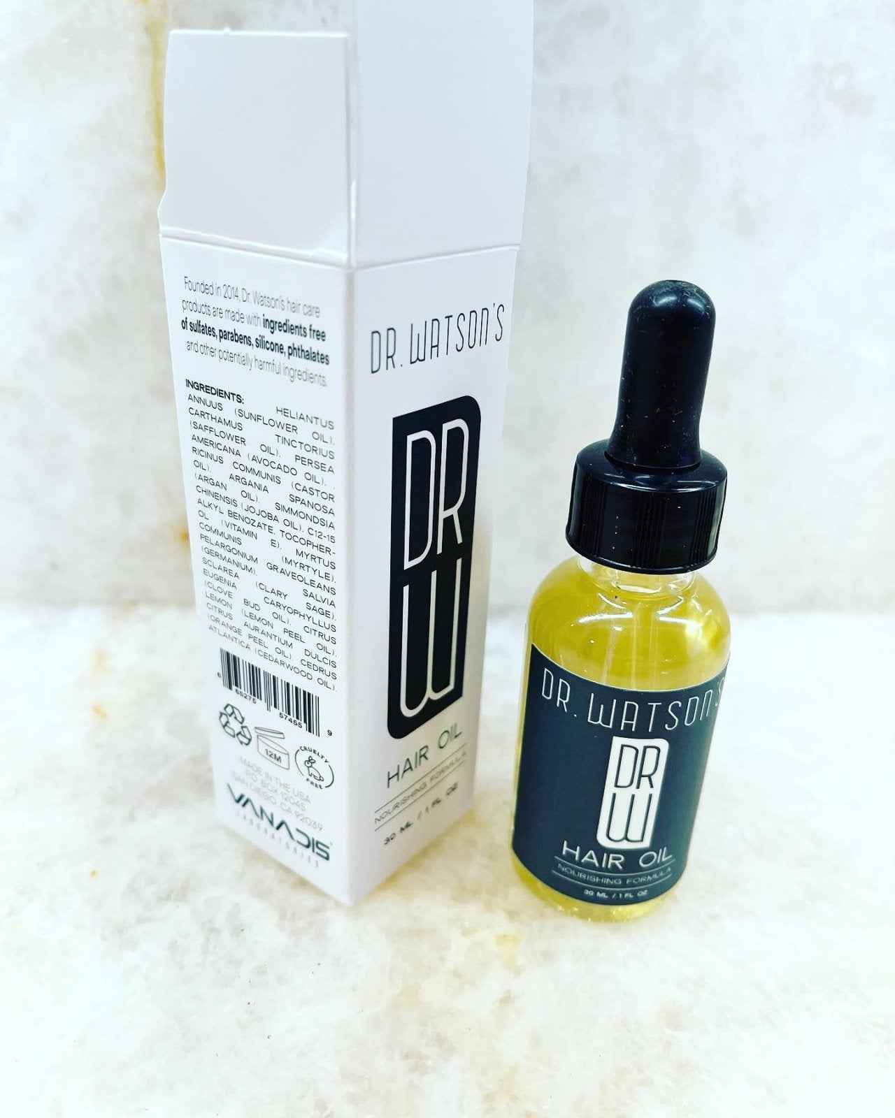 Hair oil bottle with dropper and tall white carton, dark cap and yellow oil