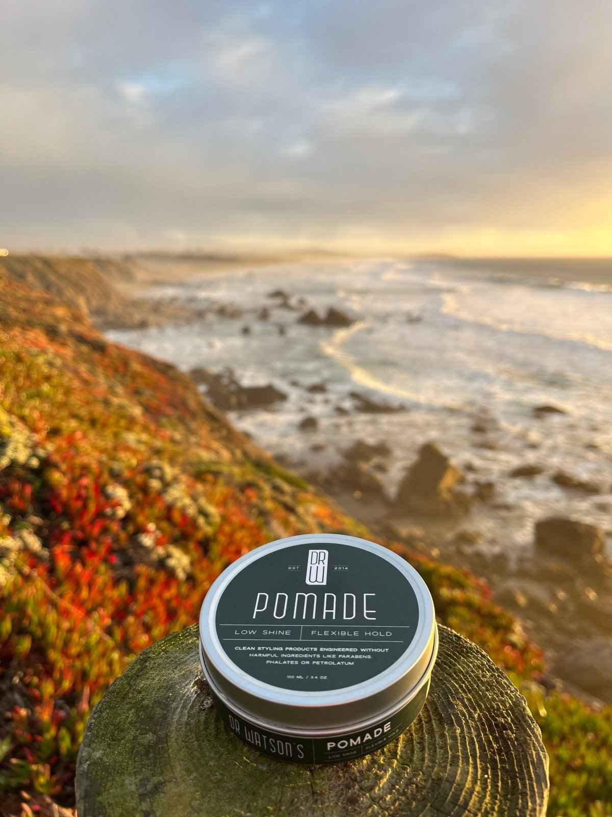 Hair pomade tin with dark green label and silver lid
