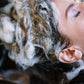 Shampoo foam on dark hair and scalp, face partially lathered